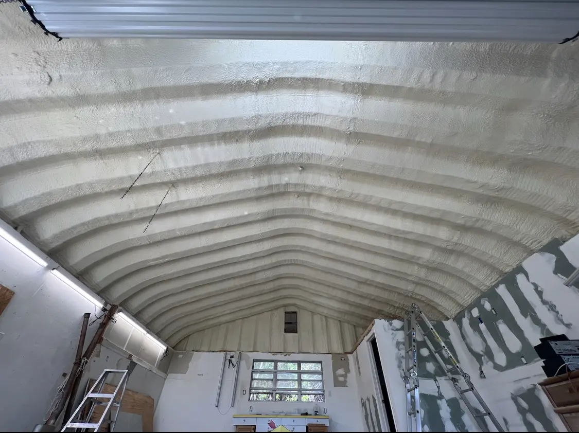 Spray polyurethane foam applied to the underside of a metal roof deck in Harvard